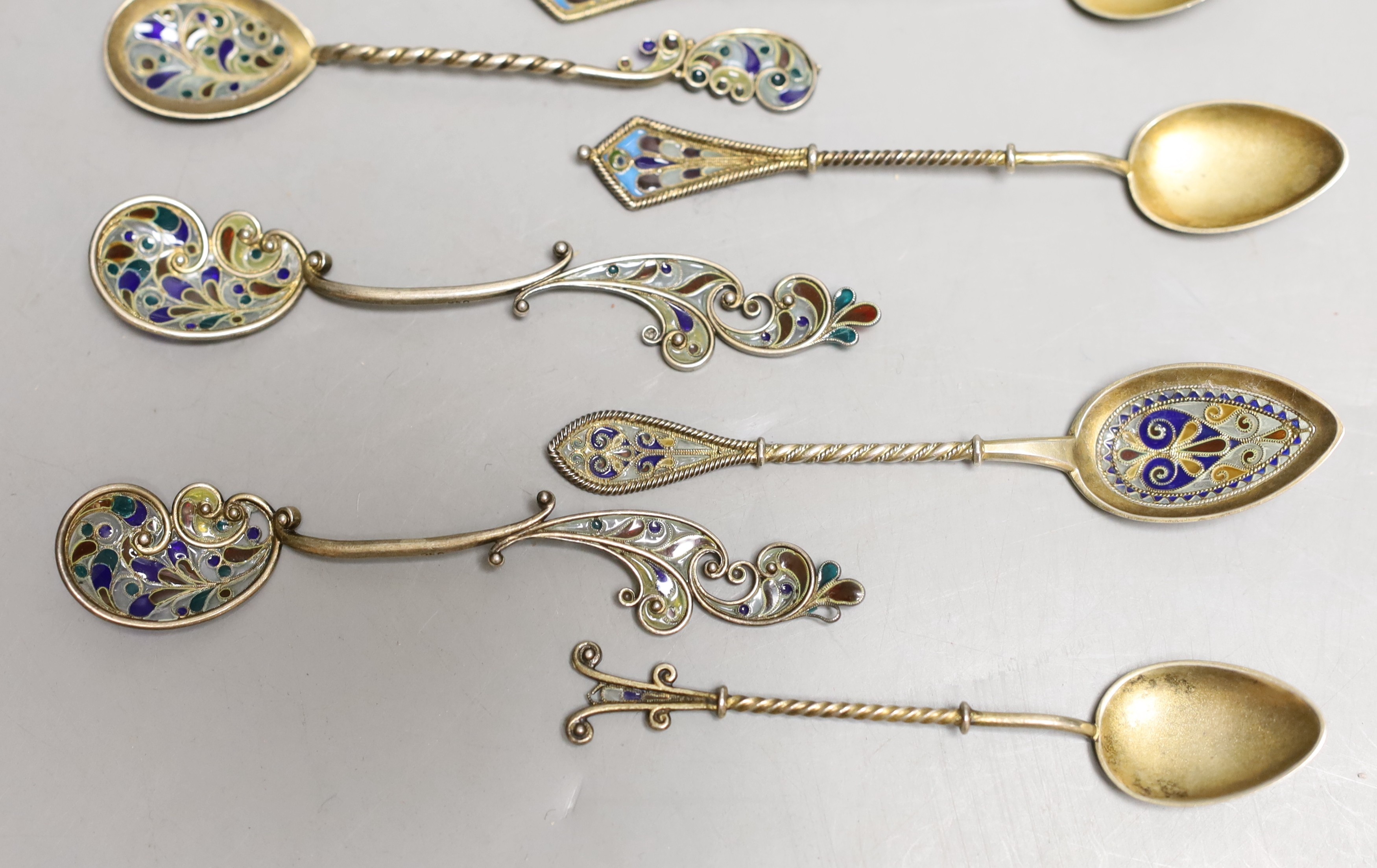 A small collection of eleven assorted Scandinavian gilt white metal and plique a jour small spoons, including four pairs, longest 11.8cm.